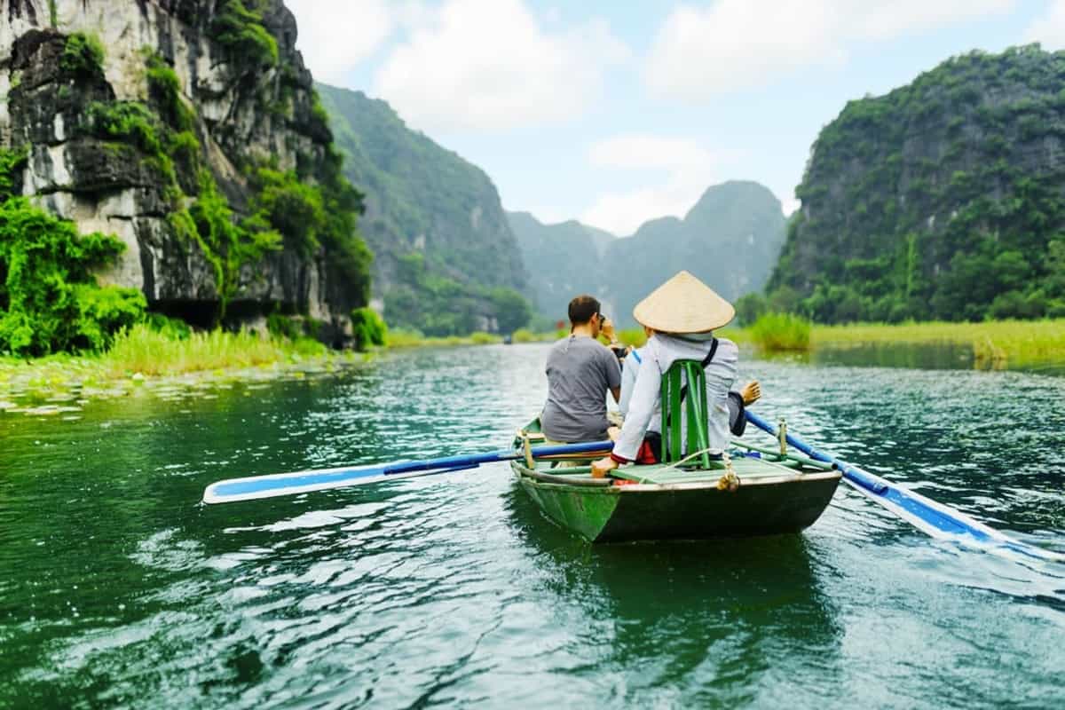 Take a boat ride in Trang An or Tam Coc